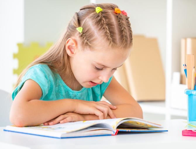 elementary girl reading a book