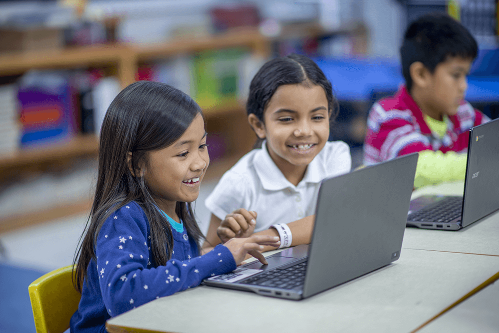 teacher and student at desk