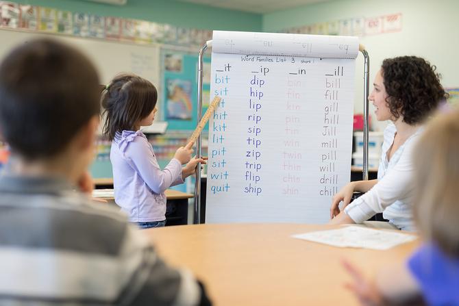 elementary age girl student learning in classroom