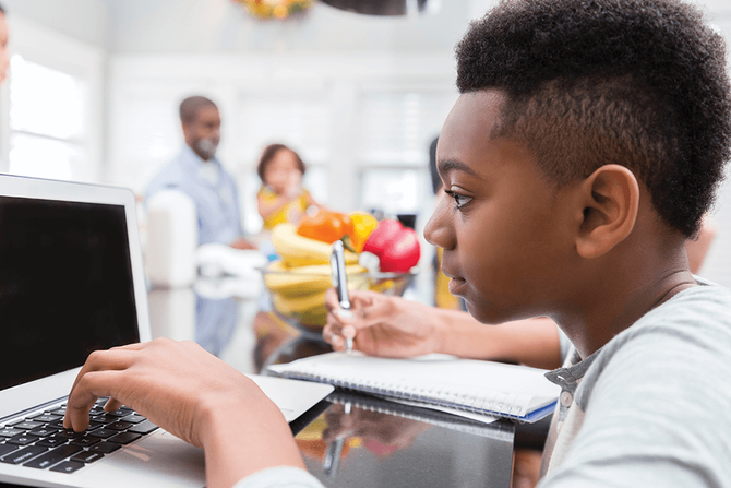 middle school student working on computer in class