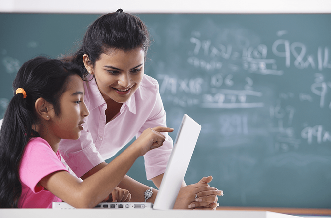 teacher working individually with student