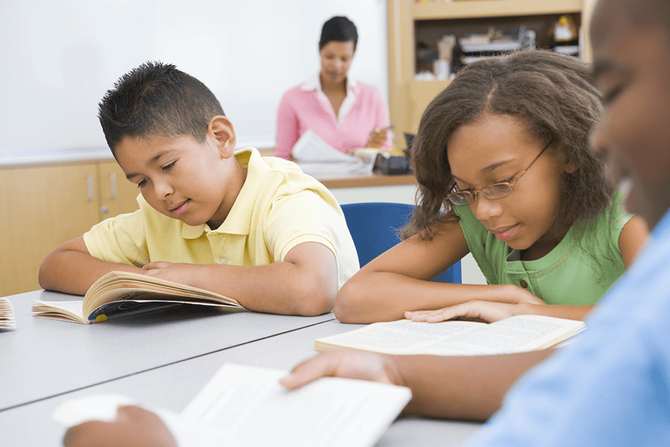 elementary students reading in a classroom