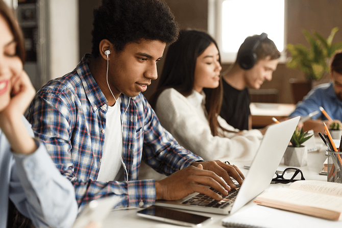 high school student working on laptop