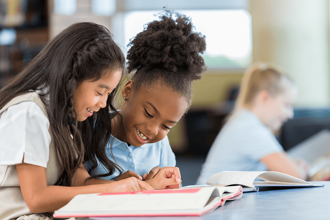elementary students reading a book