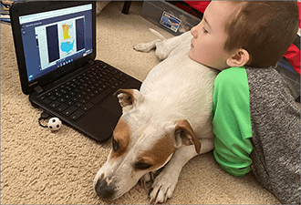 Queen Bee School District 16 student at home with dog